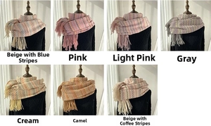 Detail showing various colors and fringe edges of thick rainbow plaid winter scarves