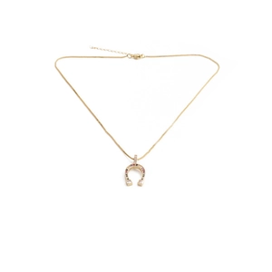 Golden horseshoe pendant necklace with multicolor zircons on a white background