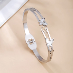 Detail of silver butterfly bangle with shell inlay and open spring mechanism