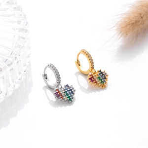 Detail of heart-shaped earrings with colorful zircon in gold and silver finishes