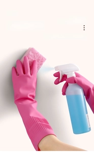Detail of pink latex gloves showing non-slip texture for kitchen cleaning use