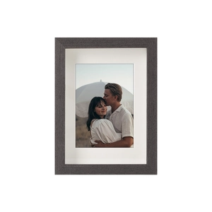 Detail of minimalist dark grey wood grain photo frame with a premium white mat insert