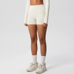 Detail view of cream high-waisted seamless yoga shorts with textured brushed fabric