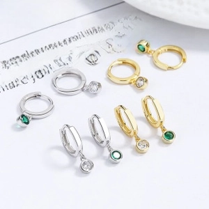 Detail of S925 sterling silver hoop earrings with white and green zircon pendants