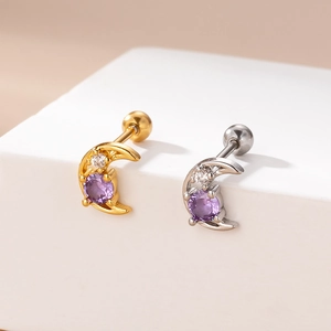 Detail of gold and silver moon earrings with purple zircons and screw back closure
