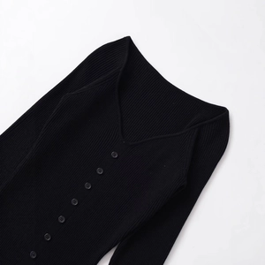Elegant black ribbed knit midi dress with V-neckline and button details on white background