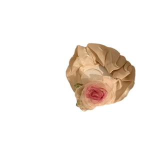Elegant beige organza hair clip with a pink rose and green leaf on white background