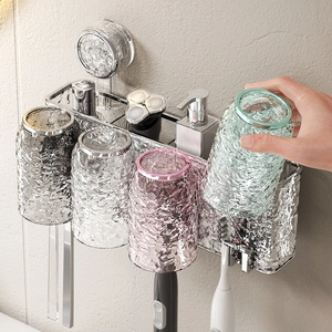 Wall-mounted suction cup toothbrush holder with four textured ripple cups for bathroom storage