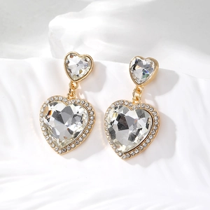 Detailed view of heart-shaped crystal drop earrings with sparkling pavé accents