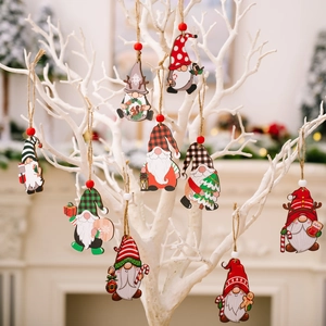 Hanging wooden Christmas gnome ornaments with red and green patterns on white branches