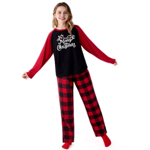Detail of Christmas pajamas featuring Merry Christmas print and buffalo plaid pants