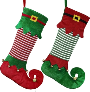 Pair of Christmas elf stockings with curled toes, festive stripes, and golden bells
