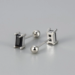 Macro detail of 925 silver screw back earring with a rectangular black zircon stone