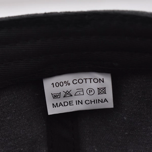 Detailed view of the 100% cotton washing label and care instructions for the baseball cap