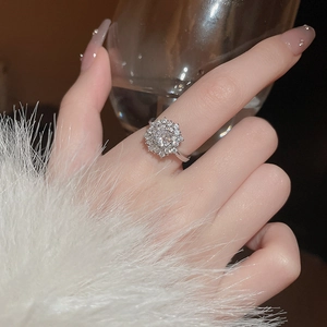 Close-up of rotating zircon snowflake ring on model hand with elegant metal luster