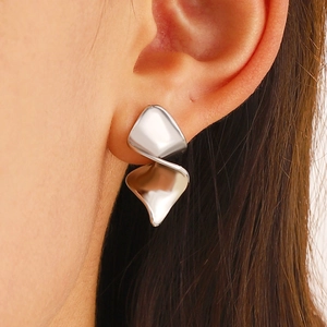 Irregular windmill-shaped silver earrings with minimalist folded geometric design