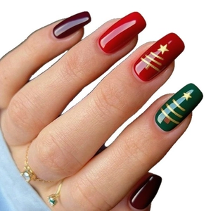 Christmas press-on nails in red and green with golden festive tree and star patterns