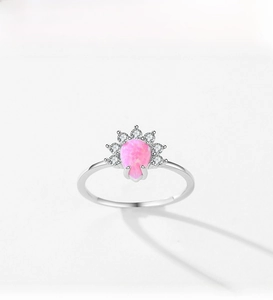 Detailed macro view of S925 silver ring featuring pink pear-cut opal with crown zircon halo