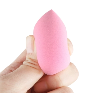 Close-up of a pink teardrop-shaped makeup sponge showing soft texture and fine pores