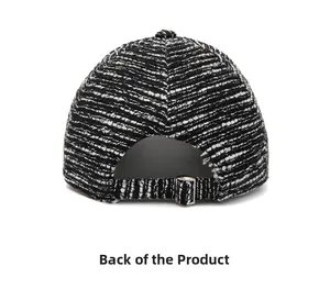 Detail of black and white tweed baseball cap back showing adjustable strap and metal buckle