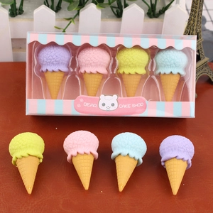 Detailed view of colorful ice cream shaped erasers in gift box and loose on wood surface