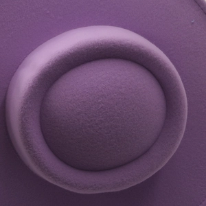 Close-up of high-quality purple wool felt fabric texture on a wide-brim jazz fedora hat