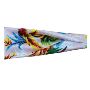 Detailed view of pink floral sweatband with vibrant tropical leaf pattern for sports