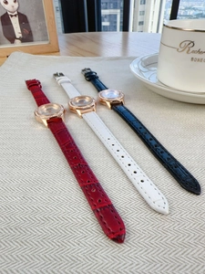 Detailed shot of leather quartz watches in red, white, and black with diamond bezel