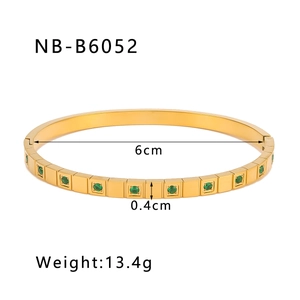 Detailed view of 18K gold plated modular bracelet with inlaid green cubic zirconia