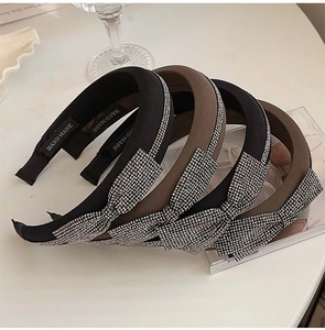 Macro shot of padded headband set with sparkling rhinestones and handmade knot detail