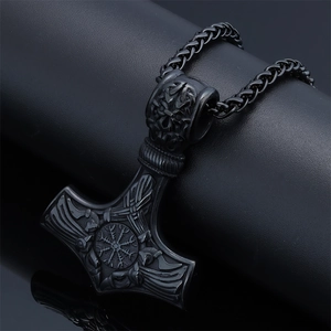 Detailed view of a black Viking Mjolnir Thor hammer pendant with intricate rune carvings