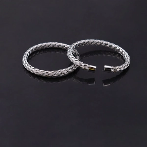 Minimalist stainless steel woven open cuff bracelets with silver finish on reflective black surface