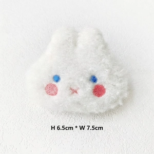 Close-up of white plush rabbit brooch showing 6.5cm by 7.5cm size measurements