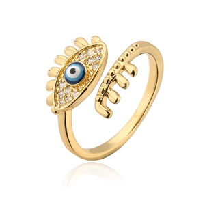 Macro detail of gold-plated evil eye ring with blue enamel and zircon eyelashes
