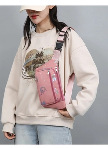 Close-up of pink oxford fanny pack with multi-layer zippers and reflective pattern