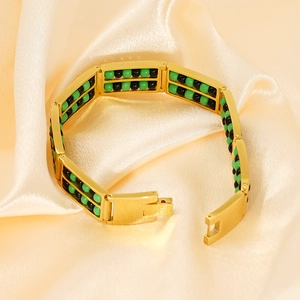Detail of 18K gold titanium bracelet with double-row green and black stone beads on silk