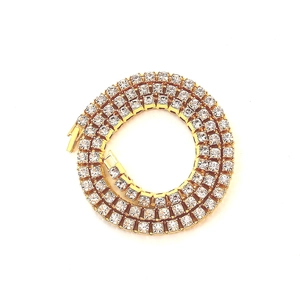 Detailed close-up of layered gold-plated tennis necklace with sparkling crystals