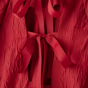 Robe rouge à manches bouffantes avec nœud lacé au dos et tissu plissé texturé