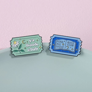 Creative enamel stamp pins with floral book club designs and colorful lettering motifs