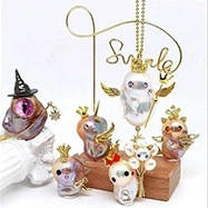 Detail showing creative S925 silver stud earrings with pearls and rabbit motifs