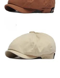 Detail of adjustable newsboy hats in beige and caramel brown with twill cotton texture