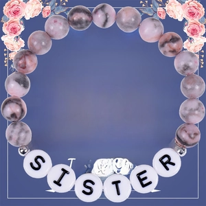 Detail of pink zebra stone beaded bracelet with SISTER lettering on a gift card