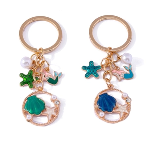 Golden ocean theme keychains featuring mermaid, starfish, shell and pearl charms