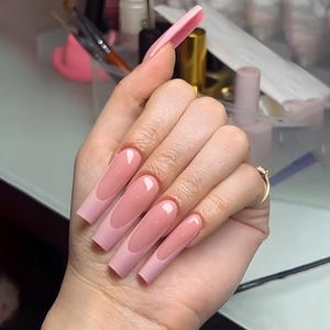 Long square French tip press-on nails in translucent light pink for a trendy salon look