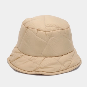 Close-up of beige quilted bucket hat with padded texture and geometric stitching