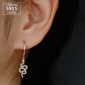 Detail of S925 sterling silver snake hoop earrings worn to show texture and scale