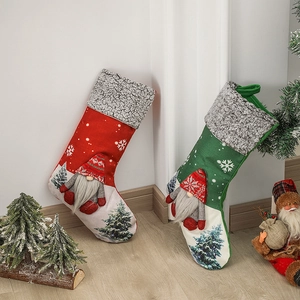 Pair of red and green plush Christmas stockings with gnome doll and snowflake design