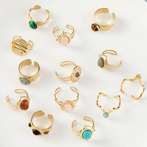 Flat lay of 12pcs vintage gold ring set with colorful stones like turquoise and pink quartz