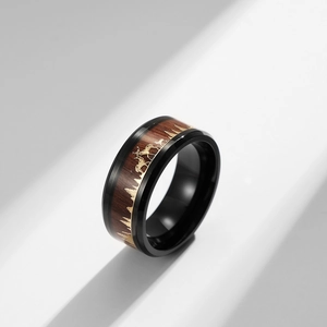 Detail of stag family engraving and natural wood inlay on the stainless steel ring band