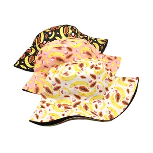 Tropical fruit print bucket hats with banana and papaya patterns in three colors